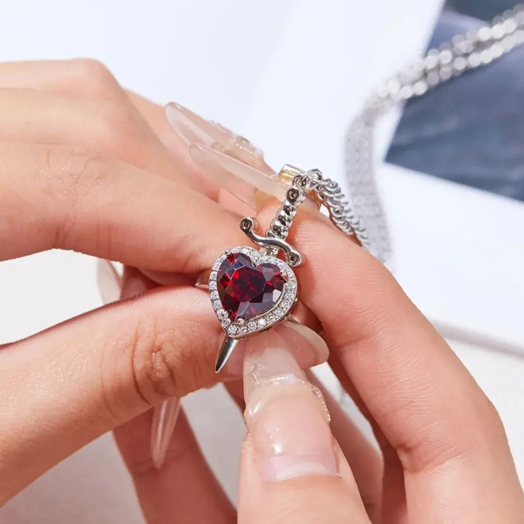 Close do anel Romantizze com coração vermelho cravejado de zircônias sendo usado na mão, destacando brilho e acabamento refinado.