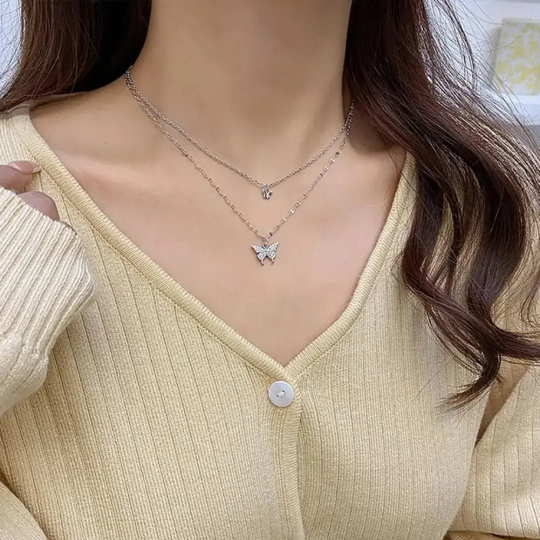 Colar feminino com pingente de borboleta usado com blusa clara, estilo delicado – Romantizze